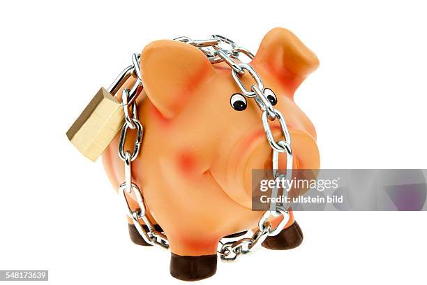 Saving money, piggy bank with chain and lock