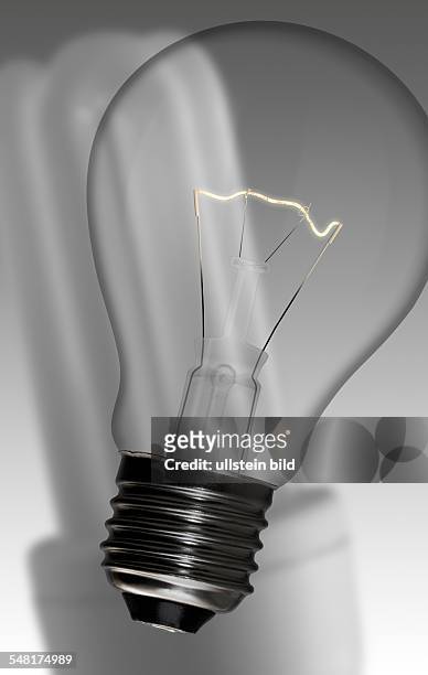 Symbolic photo light bulb, in the background an energy saving lamp