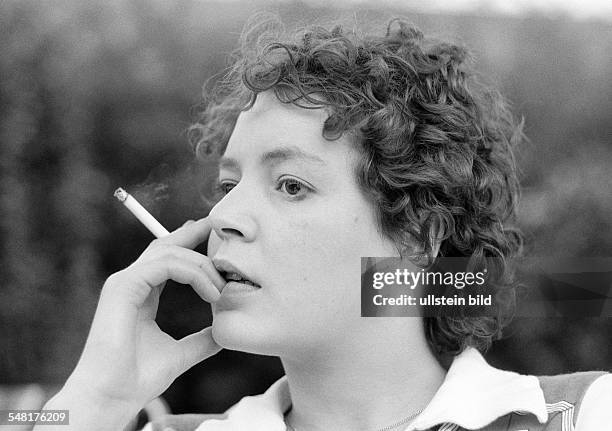 People, young woman holds a cigarette in her hand, portrait, aged 23 to 28 years, Monika -