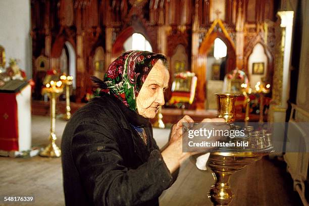 Russia Kaliningrad Kaliningrad - old woman in a church