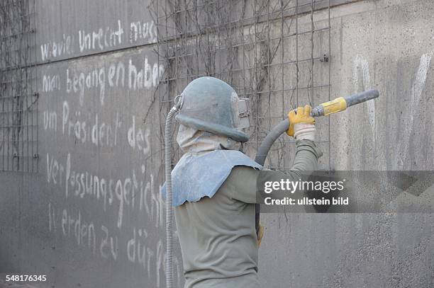 Germany Saarland Saarbruecken - removing graffity at a wall of the city highway with a special blast cleaning technology