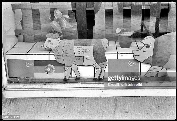 German Democratic Republic Bezirk Rostock Rostock - butcher shop; shop window with GDR flags