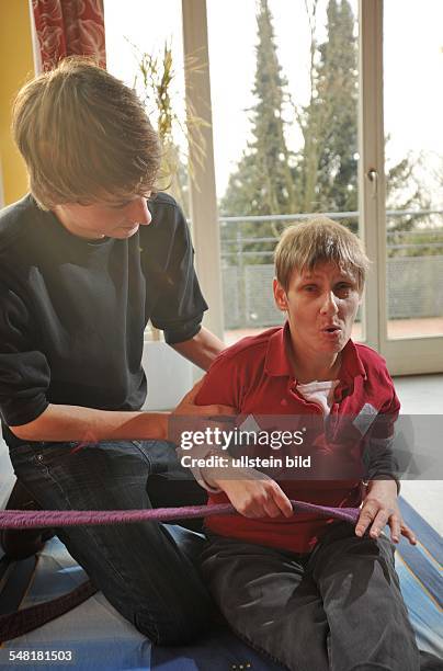 Germany Berlin Tempelhof - home for handicapped people of the Caritas organisation, house Lichtenrade, young man is doing alternative civilian...