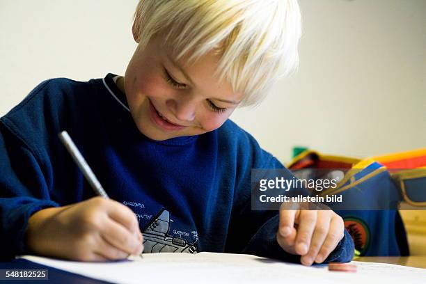 School boy of a primary school is doing his homework -
