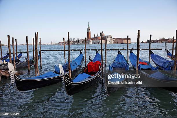 Italy Veneto Venezia - gondolas at the wharf, Benedictine monastery San Giorgio Maggiore in the background