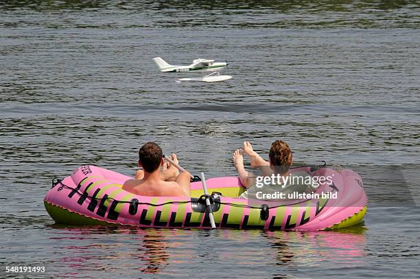 Germany Berlin Treptow - hobby pilots in a rubber boat are playing with a remote-controlle model aircraft -