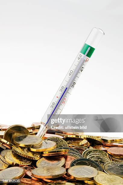 Symbolic photo crisis of the Euro, 10 Euro coins and clinical thermometer