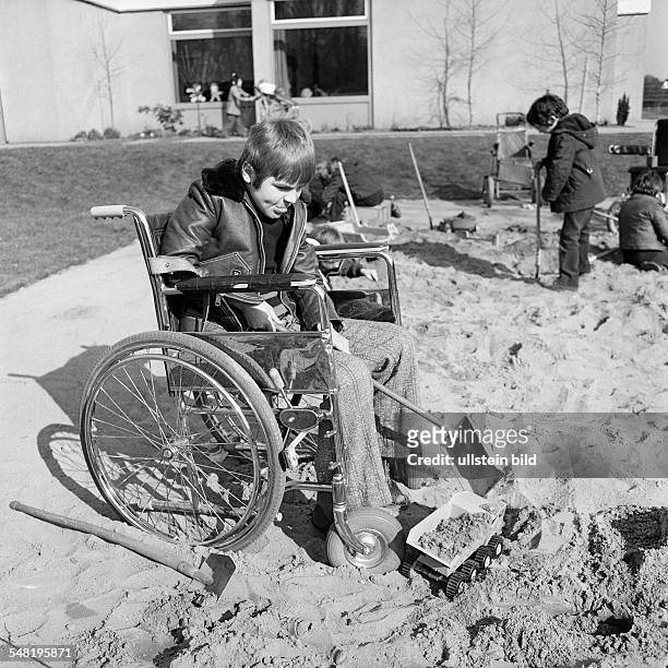 People, physical handicap, school, study break, schoolyard, boy plays with shovels in a sandpit, aged 10 to 14 years, Special School Alsbachtal,...