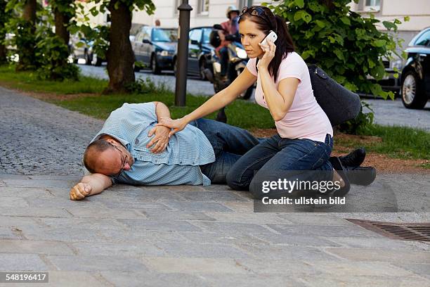 Symbolic photo heart attack, woman is giving aid -