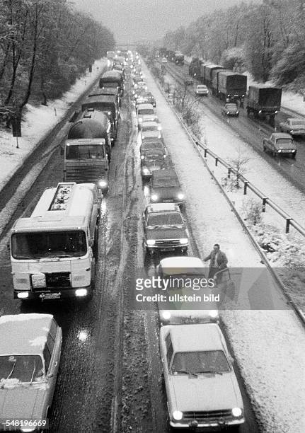 Road traffic, traffic jam on the motorway A2 near Oberhausen, twilight, winter, snow, slush, cars drive on dimmed headlights, D-Oberhausen,...