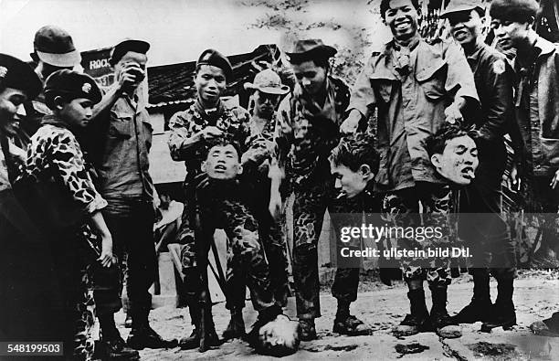 Vietnam War South Vietnamese soldiers posing with the heads of beheaded Vietcong