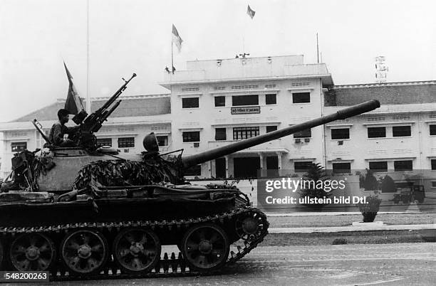 Vietnam War - South Vietnam's surrender North Vietnamese military and the Vietcong invading Saigon. A tank in front of the headquarter of the South...