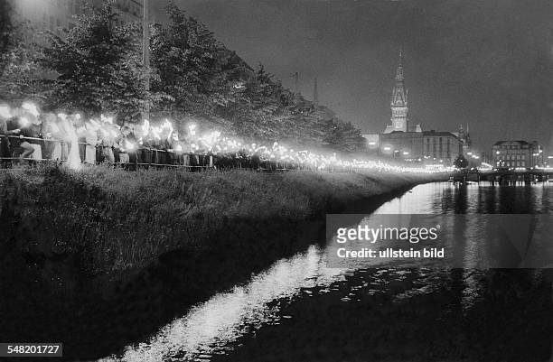 Germany Hamburg Altstadt - Students with torches are standing at the Binnenalster to commemorate the uprising at the GDR in june 1953.