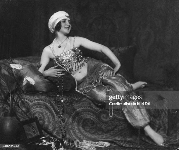 Fashion pictures Russian actress Maria Asty in an oriental costume on the divan - 1921 - Published by: 'Die Dame' 23/1921 Vintage property of...