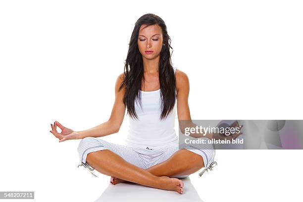 Young woman in the lotus position practising yoga