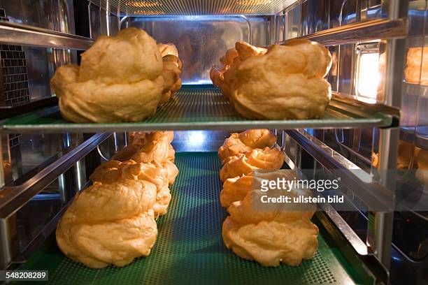 Profiteroles or cream puff pastries, baked golden-brown and fresh out of the oven