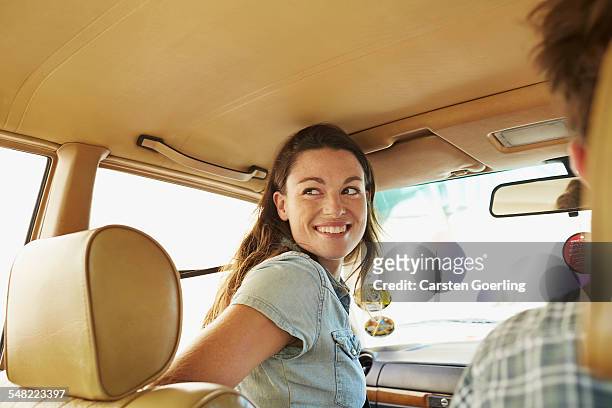 young couple on a roadtrip - passenger seat foto e immagini stock