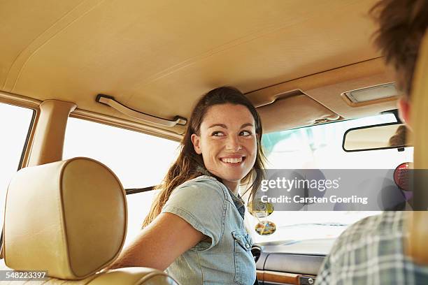 young couple on a roadtrip - couple in car smiling stock pictures, royalty-free photos & images