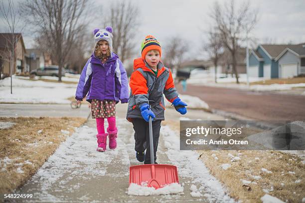little kids shoveling snow - spade stock pictures, royalty-free photos & images