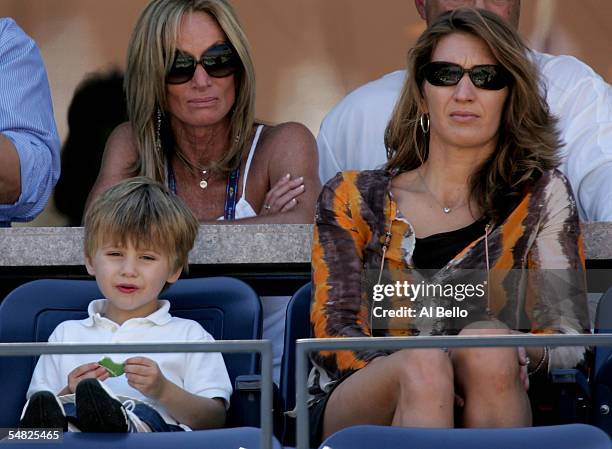 Jaden Agassi and Steffi Graff watch as Andre Agassi takes on Xavier Malisse of Belgium in the fourt round of the US Open at the USTA National Tennis...