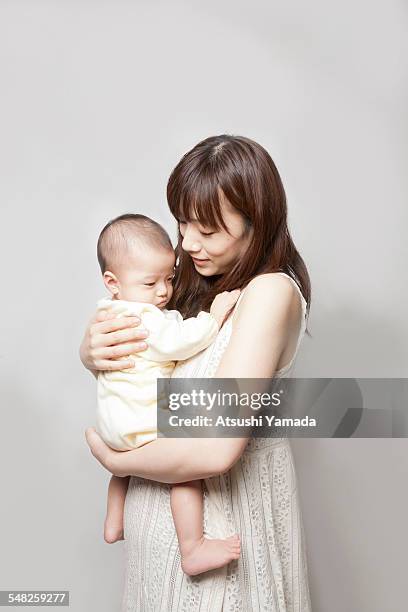 portrait of mother holding baby - 日本人　赤ちゃん ストックフォトと画像