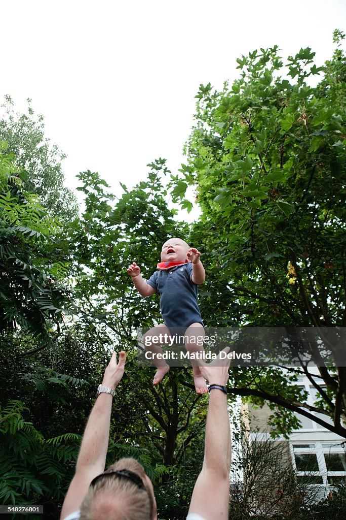 Baby boy (1 year old) being thrown in the air