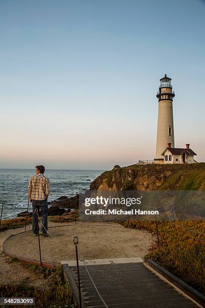 a man enjoys the dusk views at the pigeon point lighthouse near pescadero, california on a sunny day. - condado de san mateo imagens e fotografias de stock