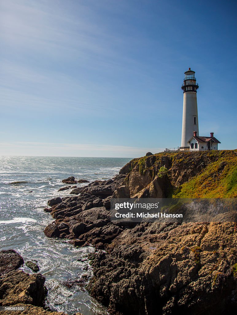 The Pigeon Point Lighthouse near Pescadero, California on a sunny day.