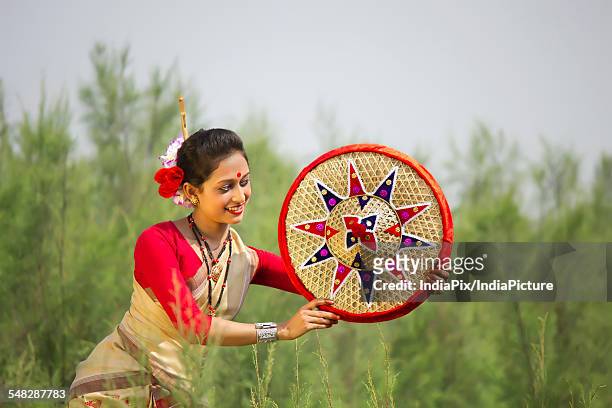 bihu dancer holding a jaapi - bihu stock pictures, royalty-free photos & images