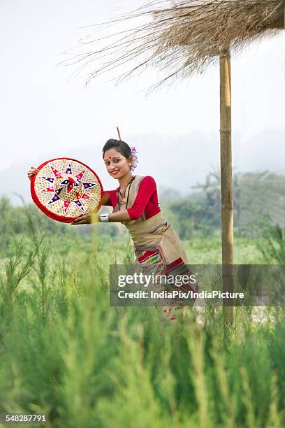 bihu dancer holding a jaapi - bihu stock pictures, royalty-free photos & images