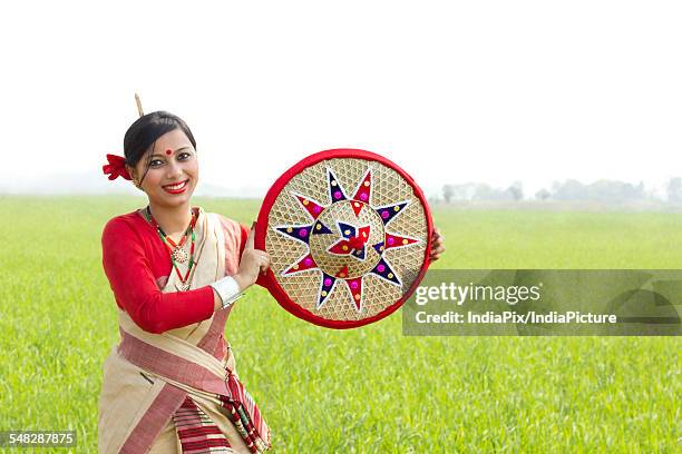 portrait of bihu woman holding a jaapi - bihu stock pictures, royalty-free photos & images