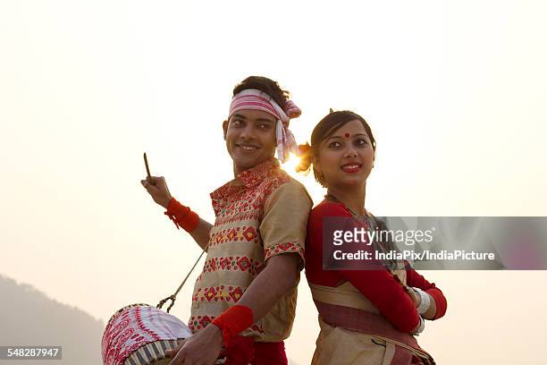 bihu dancers standing back to back - bihu stock pictures, royalty-free photos & images
