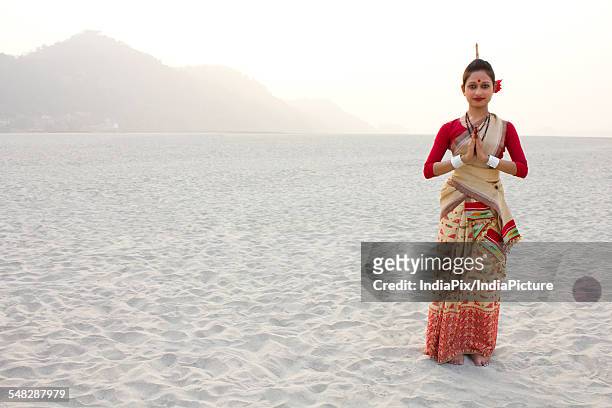 portrait of bihu dancer greeting - bihu stock pictures, royalty-free photos & images