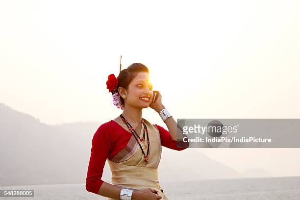 bihu woman talking on a mobile phone - bihu stock pictures, royalty-free photos & images