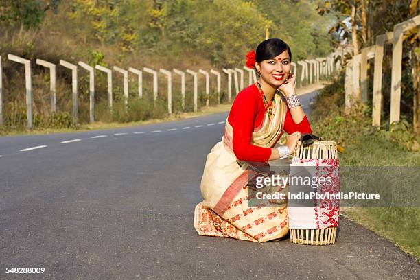 portrait of a bihu dancer with a dhol - bihu stock pictures, royalty-free photos & images