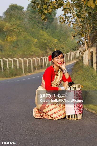 portrait of a bihu dancer with a dhol - bihu stock pictures, royalty-free photos & images