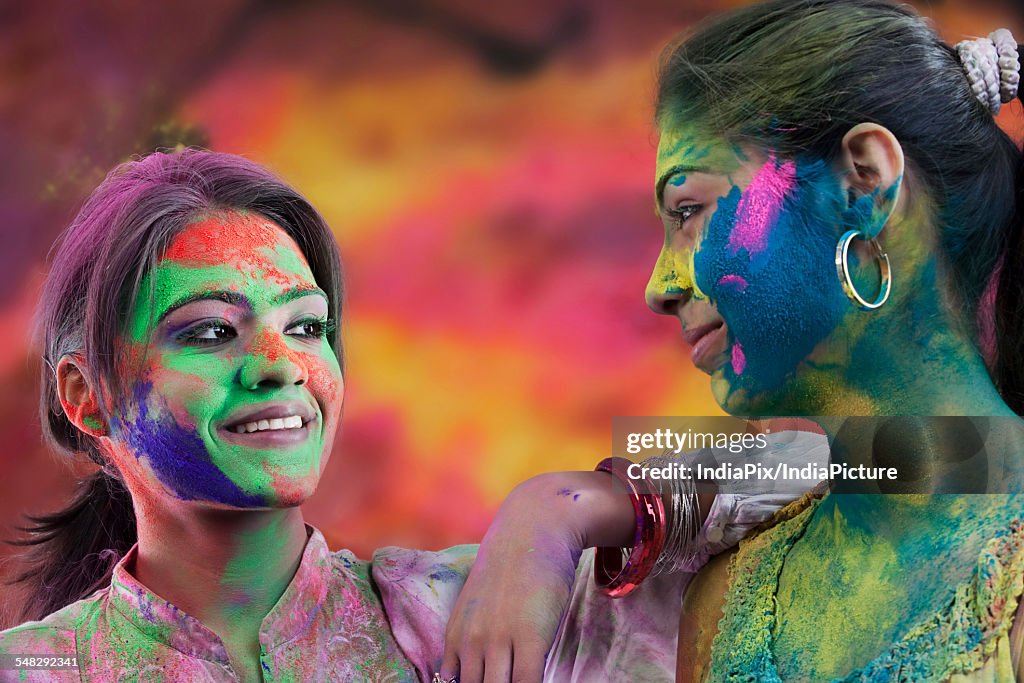 Women covered in holi colours