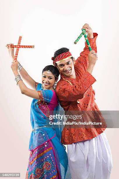 gujarati couple performing dandiya - dandiya ストックフォトと画像