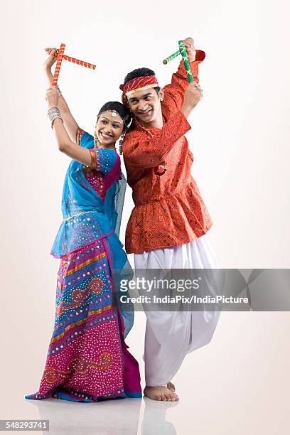 gujarati couple performing dandiya - dandiya ストックフォトと画像