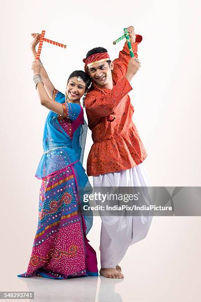 gujarati couple performing dandiya - navratri celebrations in india stock pictures, royalty-free photos & images