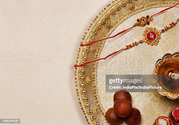 rakhi , diya and sweets in a tray  - rakhi stock pictures, royalty-free photos & images