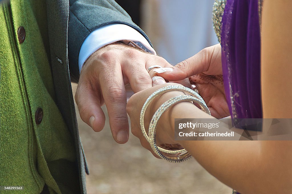 Couple exchanging rings at wedding ceremony