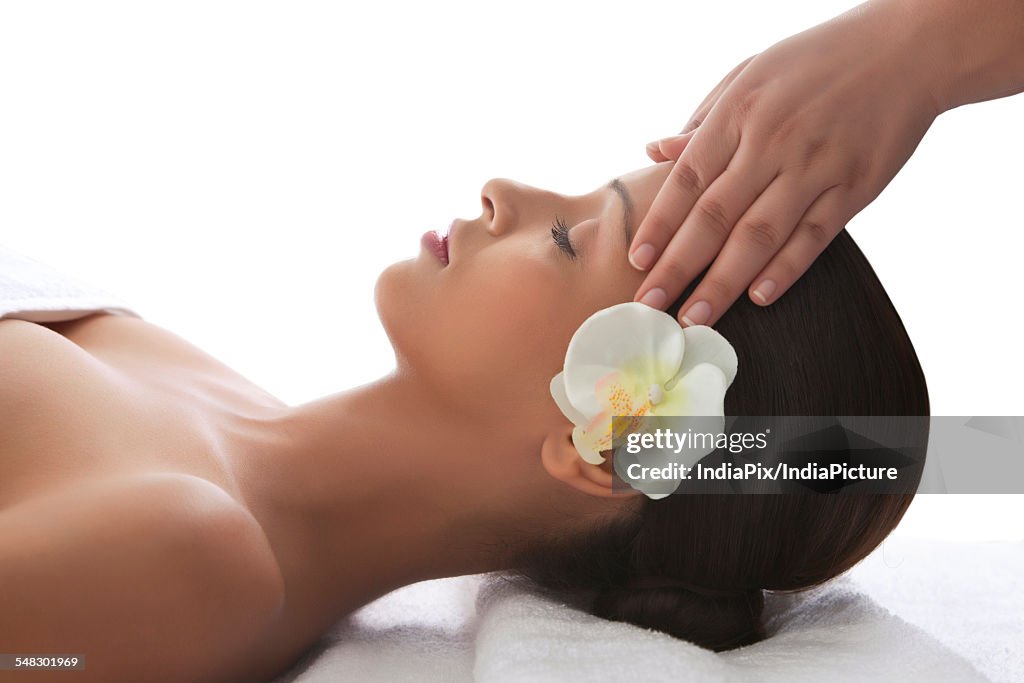 Young woman on massage table getting head massage