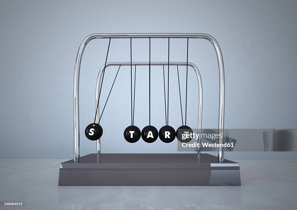 Newton's cradle with word START written on it