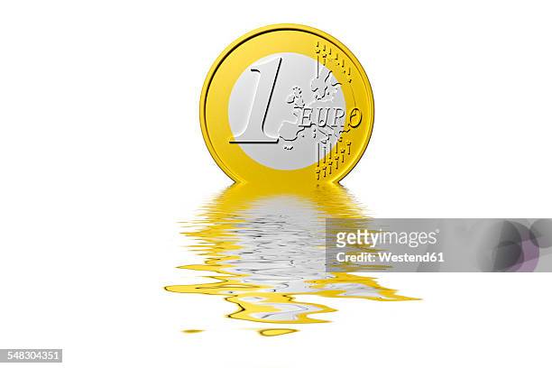 dissolving euro coin - dissolving stockfoto's en -beelden