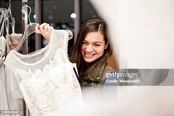 portrait of smiling young woman showing wedding dress - wedding dress stock pictures, royalty-free photos & images