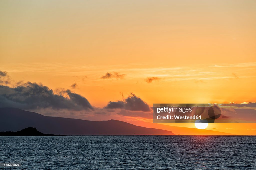 Pacific Ocean, Galapagos Islands, sunset above Santa Cruz Island