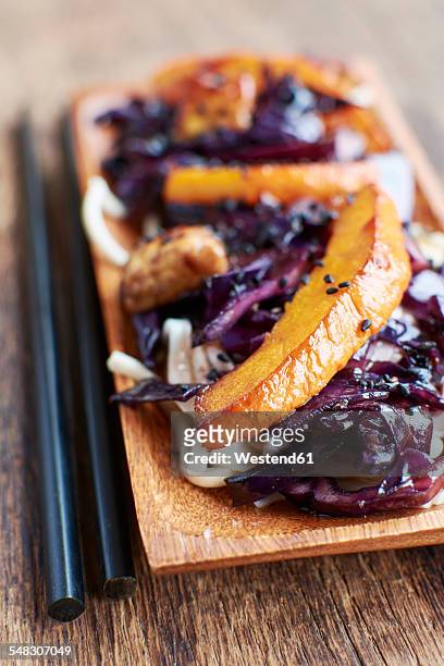 stir-fry winter vegetables with red cabbage, winter squash and tempeh on noodles - tempe stock pictures, royalty-free photos & images