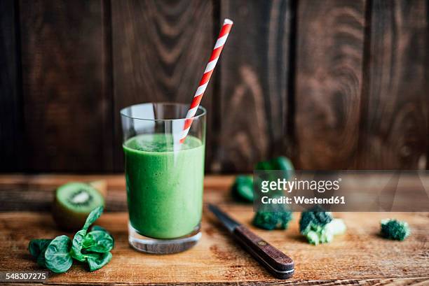 glass of green smoothie - avocado smoothie stock pictures, royalty-free photos & images