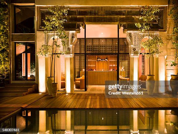 morocco, fes, hotel riad fes, courtyard with swimming pool by night - hotel entrance stock pictures, royalty-free photos & images